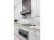 Modern kitchen with white cabinets, granite countertops and a gas cooktop at 346 Calliope St, Ocoee, FL 34761