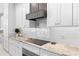 Modern kitchen with white cabinets, granite countertops and a gas cooktop at 346 Calliope St, Ocoee, FL 34761