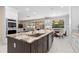 Eat-in kitchen with island, stainless steel appliances, and granite countertops at 346 Calliope St, Ocoee, FL 34761
