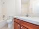 Bathroom featuring a shower-tub combo and single sink vanity with granite counters at 36502 Barrington Dr, Eustis, FL 32736