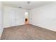 Neutral carpeted bedroom with white walls, closet, and entry door at 36502 Barrington Dr, Eustis, FL 32736