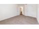 Bedroom with neutral carpet, white walls, and an open doorway to the bathroom at 36502 Barrington Dr, Eustis, FL 32736