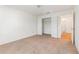 Bright bedroom featuring neutral carpet, white walls, and a closet with open doors at 36502 Barrington Dr, Eustis, FL 32736