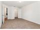 Bright bedroom featuring neutral carpet, a closet, and an open doorway at 36502 Barrington Dr, Eustis, FL 32736