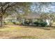 Charming single-story home with mature trees, manicured shrubs, and a well maintained lawn at 36502 Barrington Dr, Eustis, FL 32736