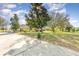 Well maintained property featuring a white home with mature trees and landscaping at 36502 Barrington Dr, Eustis, FL 32736