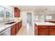 Bright kitchen with stainless steel appliances, wood cabinetry, and granite countertops at 36502 Barrington Dr, Eustis, FL 32736