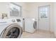 Bright laundry room with washer and dryer units and tiled flooring at 36502 Barrington Dr, Eustis, FL 32736