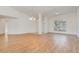 Spacious open concept living room with wood floors, columns, and lots of natural light at 36502 Barrington Dr, Eustis, FL 32736