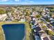 Aerial view of a house near a pond in a residential area at 388 Westwind Ct, Lake Mary, FL 32746