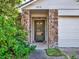 Front entrance with stone columns and a glass front door at 388 Westwind Ct, Lake Mary, FL 32746