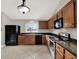 Kitchen with wood cabinets, granite countertops, and black appliances at 388 Westwind Ct, Lake Mary, FL 32746