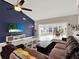 Spacious living room featuring a large sectional sofa, a TV, and access to a sunroom at 388 Westwind Ct, Lake Mary, FL 32746