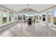 Sunroom with tile floor, table and chairs, and multiple windows at 388 Westwind Ct, Lake Mary, FL 32746