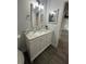 Updated bathroom with vanity, marble countertop, and large mirror at 4010 Winderlakes Dr, Orlando, FL 32835