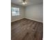 Bright bedroom featuring wood-look flooring and ceiling fan at 4010 Winderlakes Dr, Orlando, FL 32835