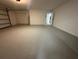 Spacious two-car garage with painted floor and extra storage space at 4010 Winderlakes Dr, Orlando, FL 32835