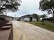 White brick house with a three-car garage and a long driveway at 4010 Winderlakes Dr, Orlando, FL 32835