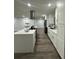 Modern kitchen with white cabinets, island, and stainless steel appliances at 4010 Winderlakes Dr, Orlando, FL 32835