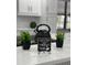Kitchen counter with coffee sign and small plants at 4010 Winderlakes Dr, Orlando, FL 32835