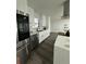 Modern kitchen with stainless steel appliances and white cabinets at 4010 Winderlakes Dr, Orlando, FL 32835
