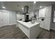 Modern kitchen with white cabinets and a large island at 4010 Winderlakes Dr, Orlando, FL 32835