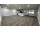 Open concept living area with grey wood-look floors at 4010 Winderlakes Dr, Orlando, FL 32835