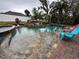 Relaxing pool with flagstone coping and waterfall feature at 4010 Winderlakes Dr, Orlando, FL 32835