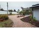 A brick paved walkway leads to a refreshing pool area with tropical landscaping at 4010 Winderlakes Dr, Orlando, FL 32835