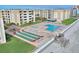 Aerial view of beachside community with pool, shuffleboard, and ocean access at 4175 S Atlantic Ave # 4070, New Smyrna Beach, FL 32169