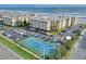 Aerial view of building, parking, and tennis court at 4175 S Atlantic Ave # 4070, New Smyrna Beach, FL 32169