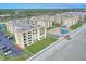 Aerial view showcasing beachfront building, pool, and ample parking at 4175 S Atlantic Ave # 4070, New Smyrna Beach, FL 32169