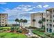 Oceanfront property with walkway, lush landscaping, and pool at 4175 S Atlantic Ave # 4070, New Smyrna Beach, FL 32169