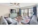 Relaxing living room featuring two sofas and access to a balcony at 4175 S Atlantic Ave # 4070, New Smyrna Beach, FL 32169