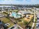 Aerial view of community pool, playground, and surrounding homes at 4567 Tribute Trl, Kissimmee, FL 34746