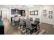 Dining area with dark wood table and chairs, and a view of the kitchen at 4567 Tribute Trl, Kissimmee, FL 34746