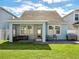 House exterior with a screened porch and yard at 4567 Tribute Trl, Kissimmee, FL 34746