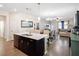 Open concept kitchen with island, stainless steel appliances, and white countertops at 4567 Tribute Trl, Kissimmee, FL 34746