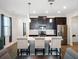 Modern kitchen with dark cabinets, white countertops and an island with seating at 4567 Tribute Trl, Kissimmee, FL 34746
