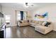 Spacious living room with large sectional sofa and wood-look flooring at 4567 Tribute Trl, Kissimmee, FL 34746