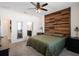 Large bedroom with wood feature wall, ceiling fan, and plush carpeting at 4567 Tribute Trl, Kissimmee, FL 34746