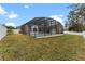 Home's backyard with a screened pool and a large grassy area at 4800 Pierce Arrow Dr, Apopka, FL 32712