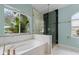 Spa-like bathroom with soaking tub, walk-in shower, and marble tile at 4800 Pierce Arrow Dr, Apopka, FL 32712