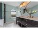 Modern bathroom with a double vanity, large mirrors, and walk-in shower at 4800 Pierce Arrow Dr, Apopka, FL 32712