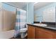 Clean bathroom with shower/tub combo and wood cabinets at 4800 Pierce Arrow Dr, Apopka, FL 32712