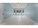Spacious bedroom with light blue walls and marble-look tile floors at 4800 Pierce Arrow Dr, Apopka, FL 32712