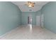 Large bedroom with light blue walls and marble-look floors at 4800 Pierce Arrow Dr, Apopka, FL 32712