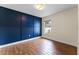Bedroom with dark blue accent wall and wood-look floors at 4800 Pierce Arrow Dr, Apopka, FL 32712