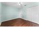 Bedroom with light teal walls, ceiling fan and double closets at 4800 Pierce Arrow Dr, Apopka, FL 32712