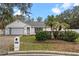 Single story house with gray garage door and palm trees at 4800 Pierce Arrow Dr, Apopka, FL 32712